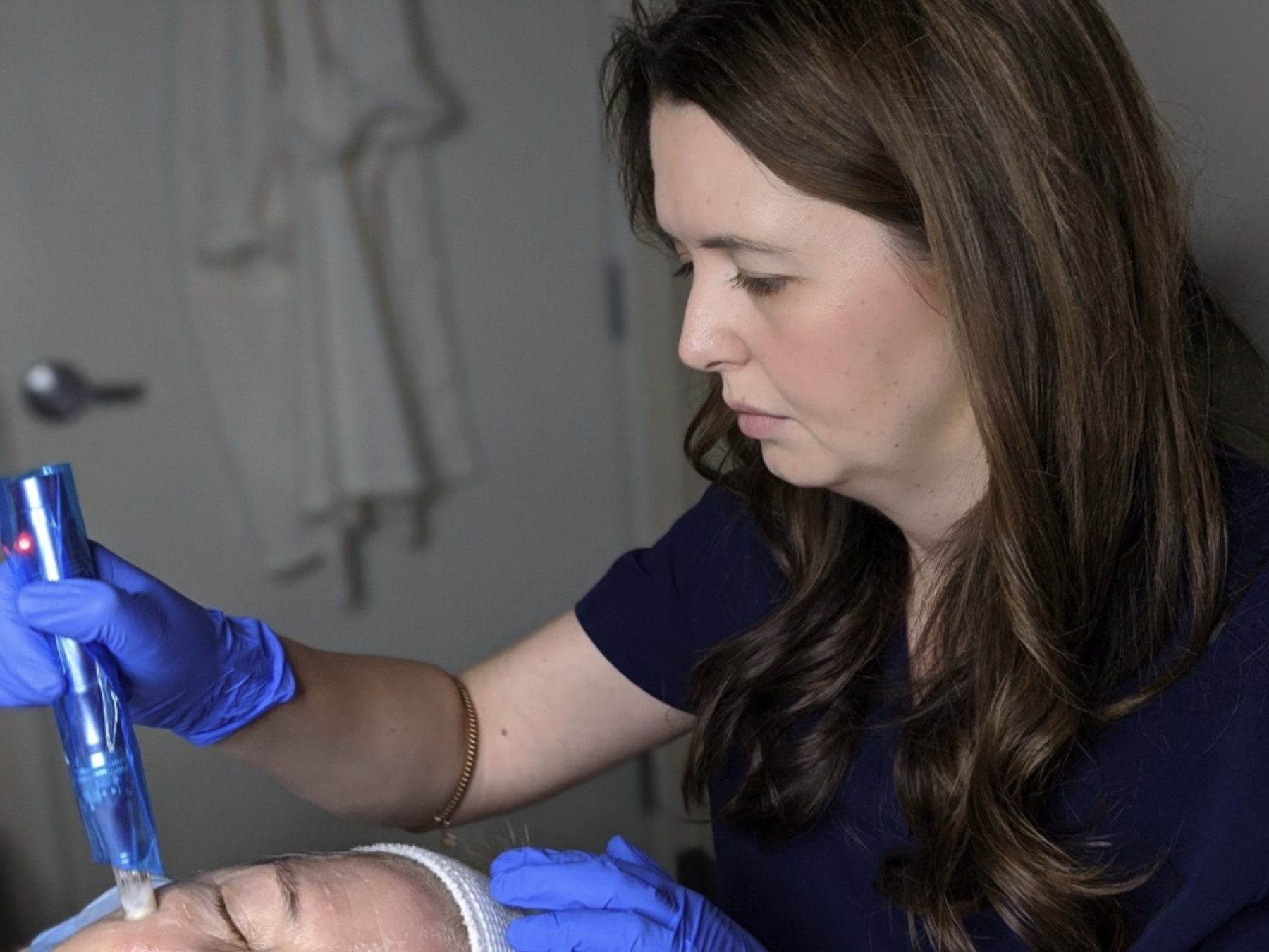Dr. Sarah performing a microneedling treatment